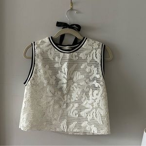 White mesh sleeveless crew neck top.